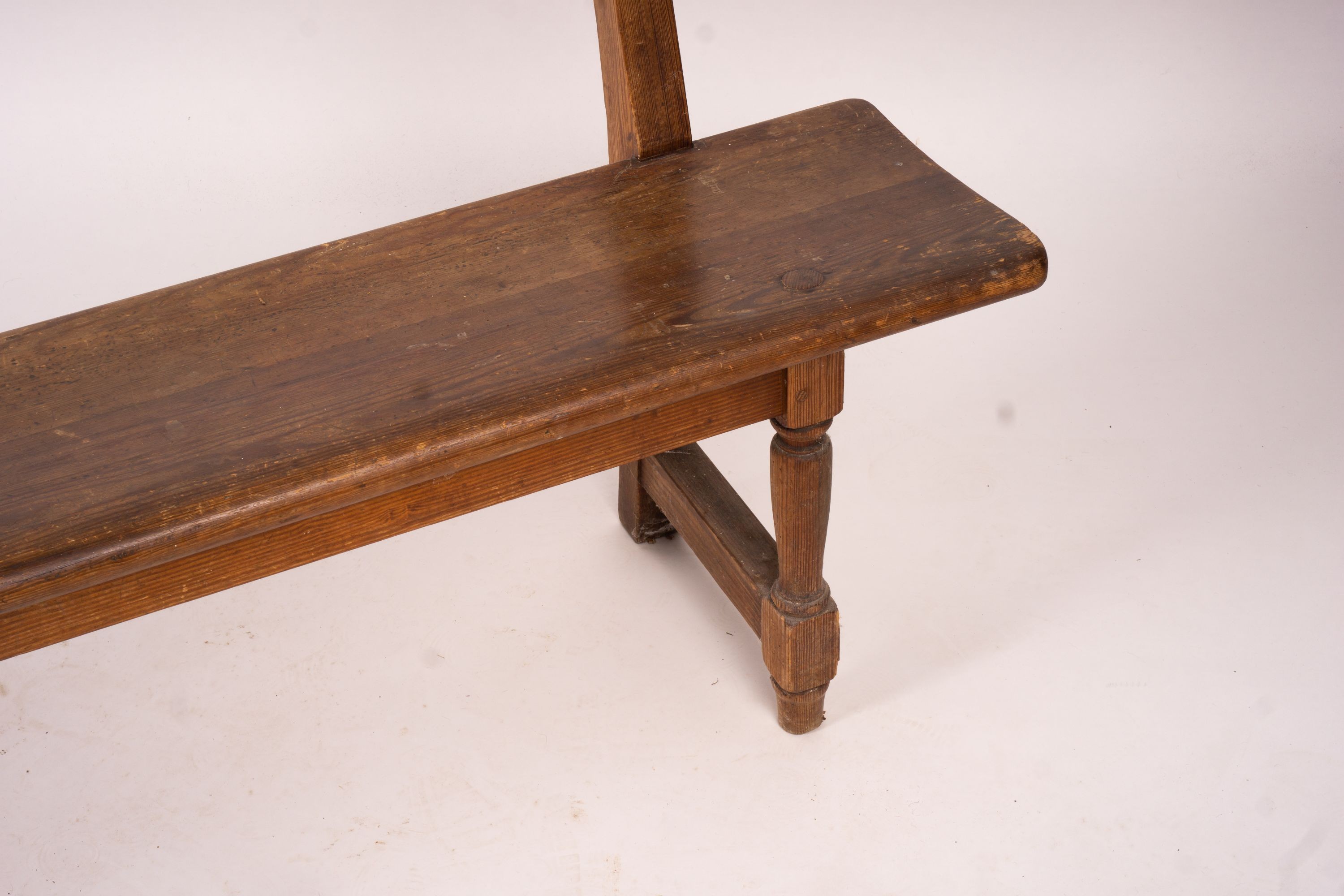 A Victorian pitch pine bench seat, W.214cm H.79cm